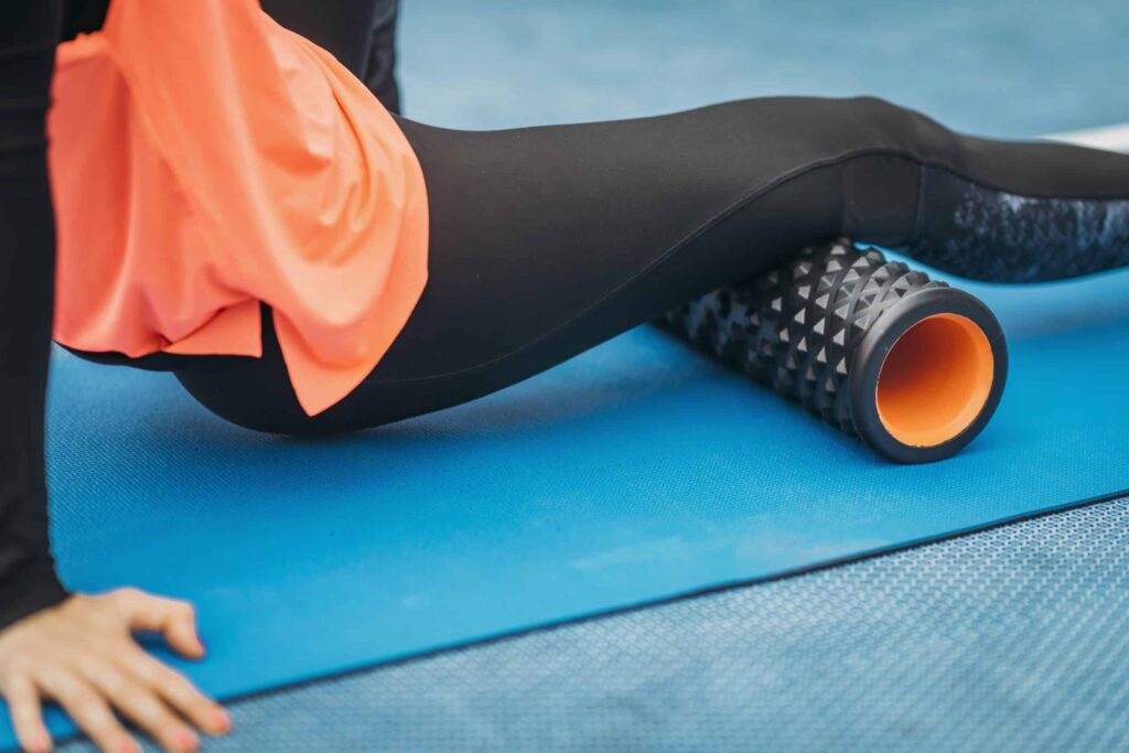 Female Athlete using Foam Roller