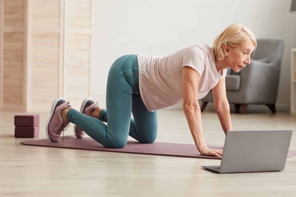 Senior woman exercising on the floor
